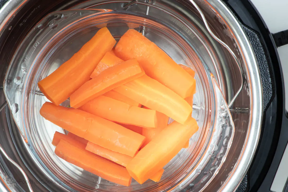 Steamed carrots in Instant Pot in a glass bowl.