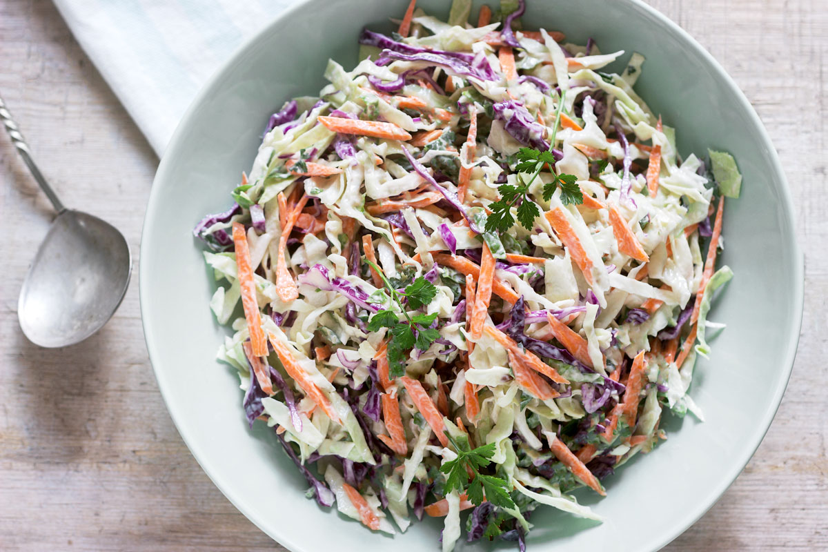 Simplw summer coleslaw in a green bowl. 