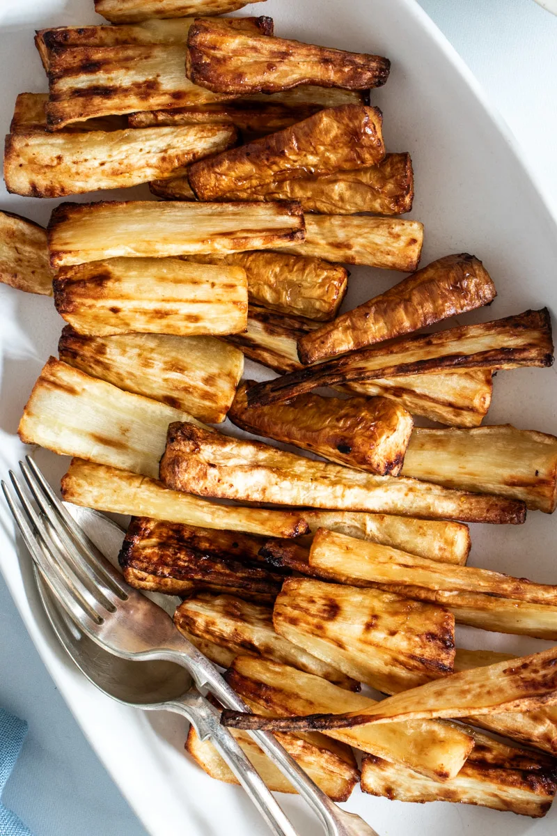 Air fryer roast parsnips on a white dish.