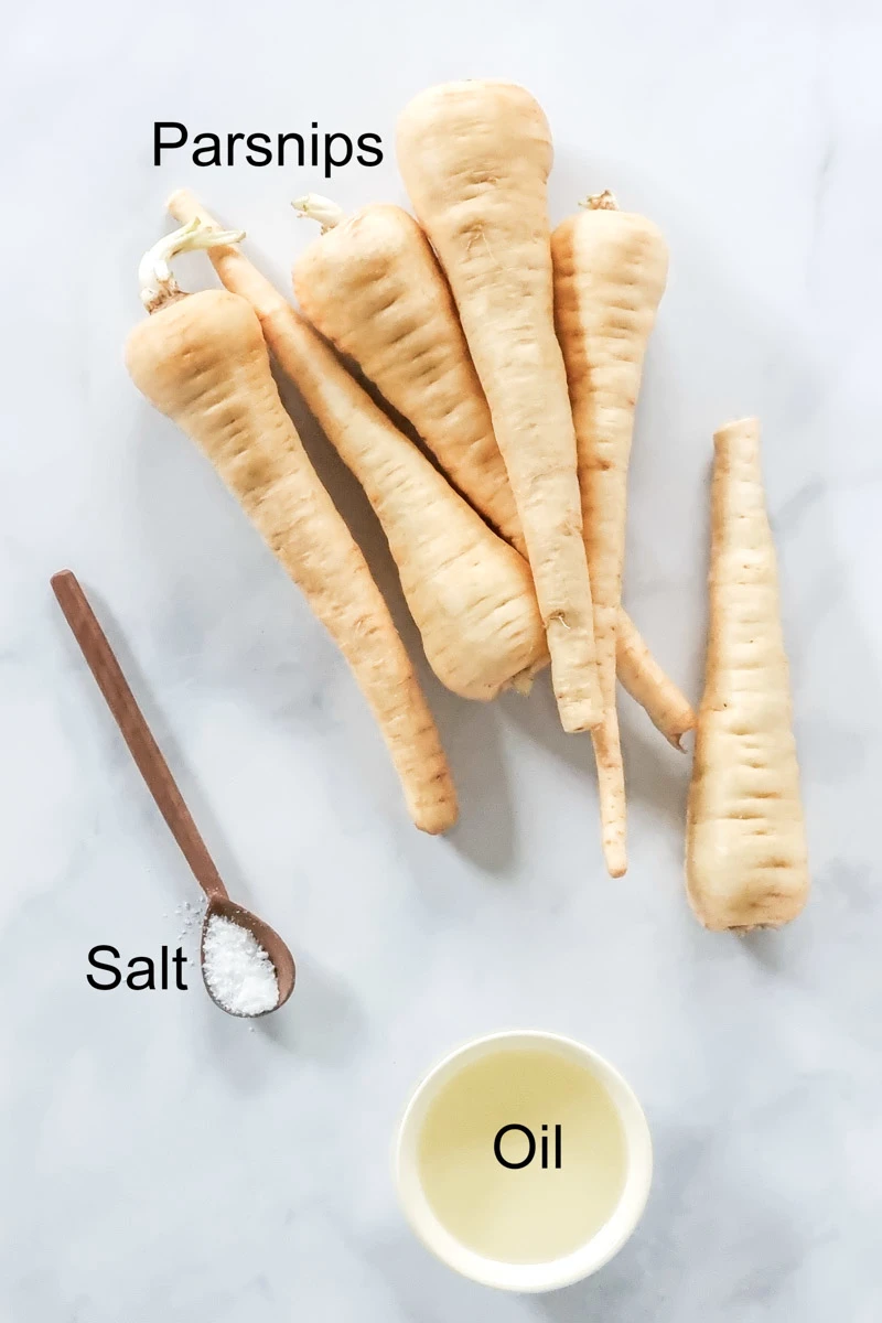 A flat-lay image of the ingredients for this air fryer roasted parsnips recipe.