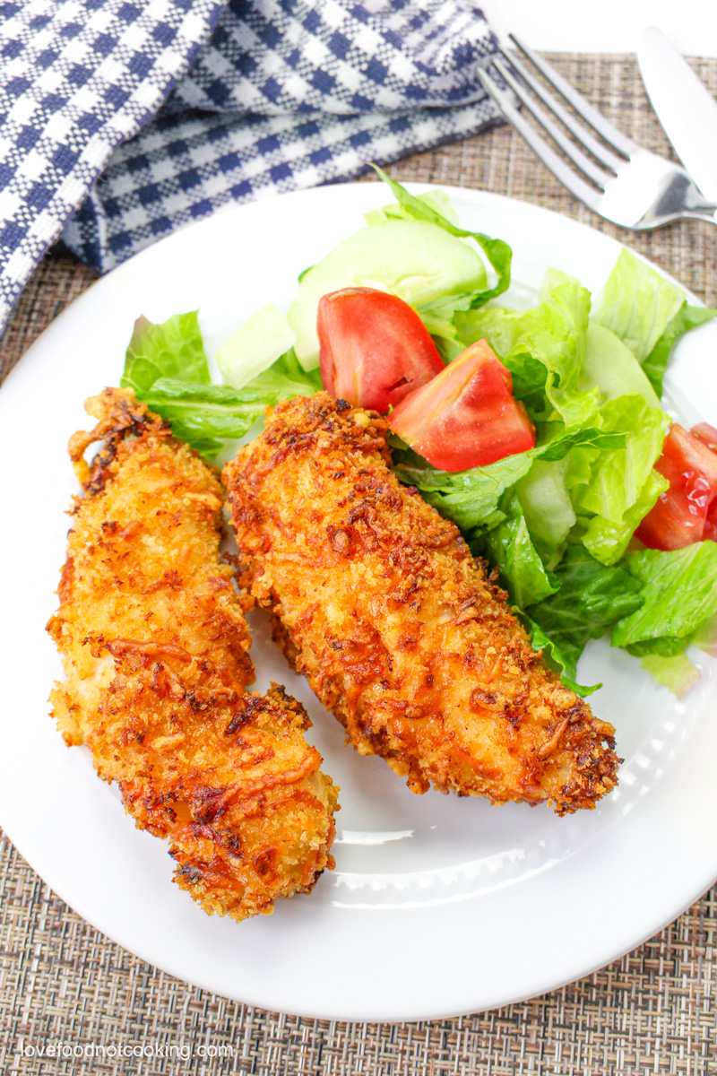 Air fried chicken tenders on a white plate.