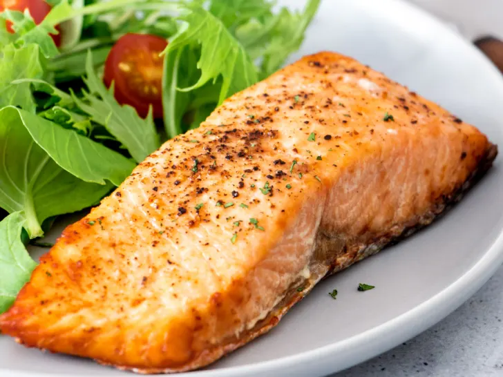 Air fryer salmon on a gray plate.