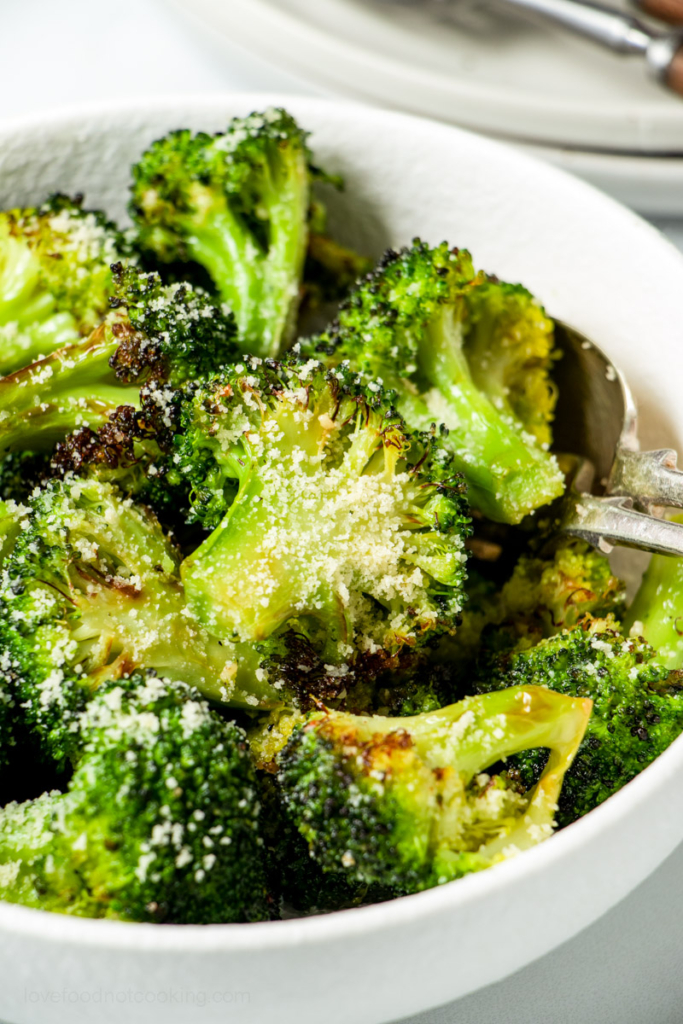 Air fried broccoli in a white bowl.