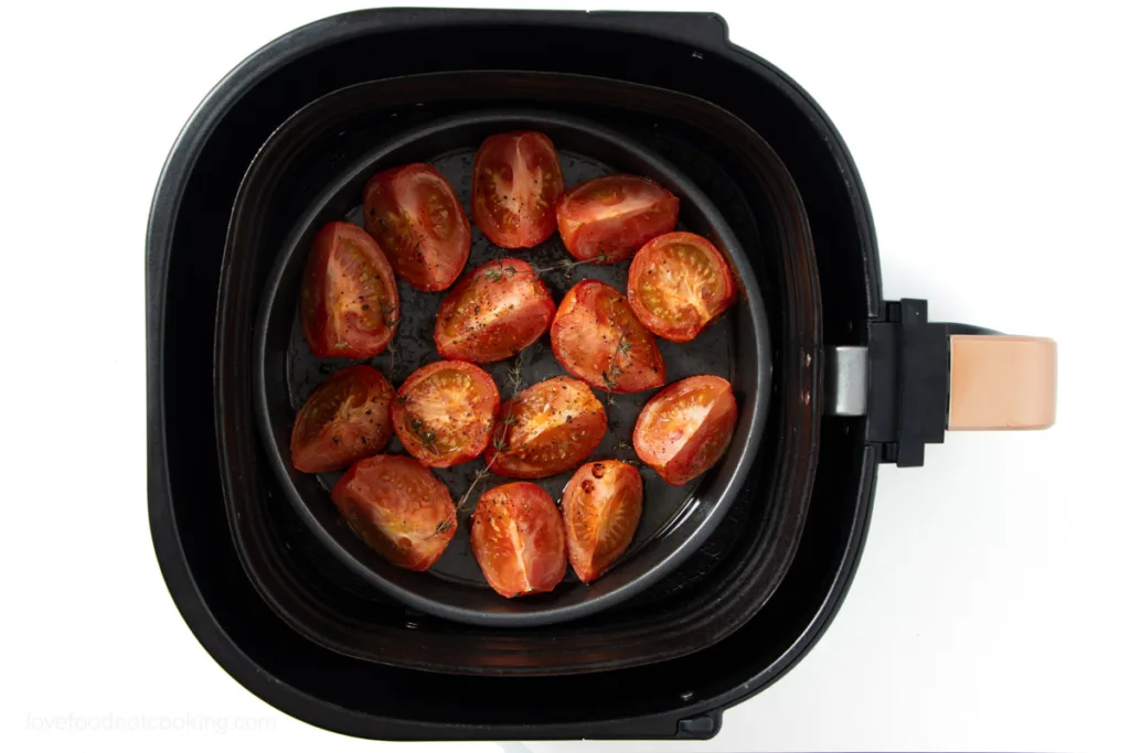 Air fried tomatoes in air fryer basket. 