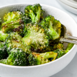 Air fryer broccoli in a white bowl.