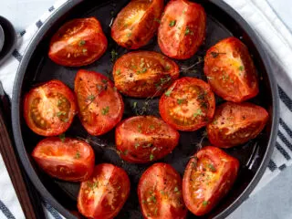 Air fryer tomatoes in a round baking dish.