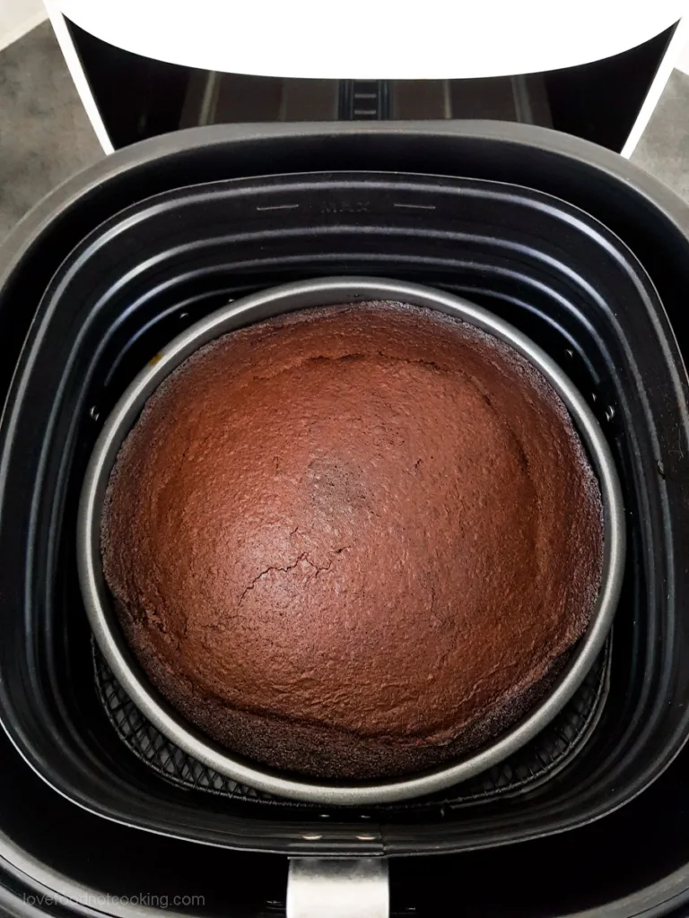 A pan of baked brownies in air fryer basket. 