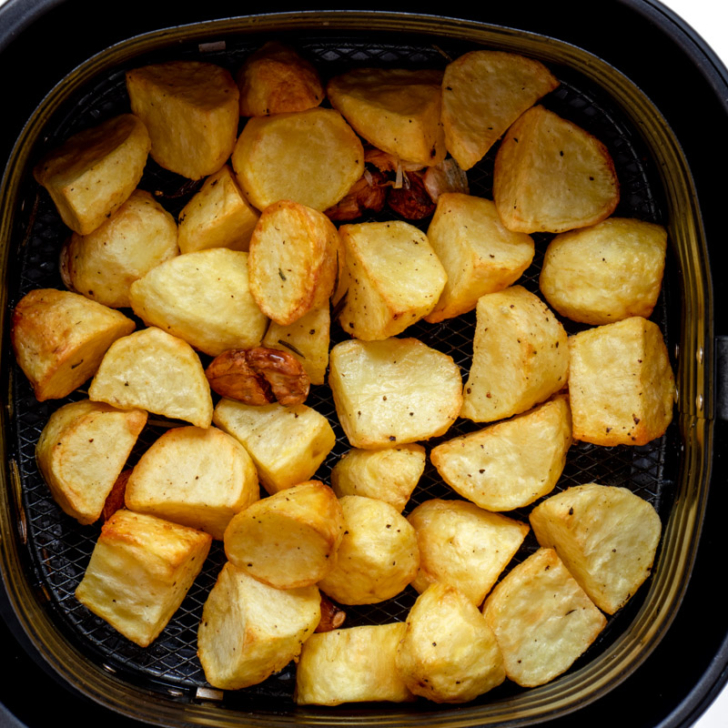 Cooked roast potatoes in air fryer basket. 
