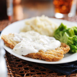 Air fryer chicken fried steak on a white plate.