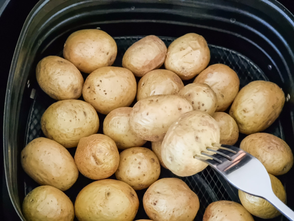 Fork tender baby potatoes in air fryer basket. 
