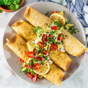 Air fryer taquitos on a grey plate.