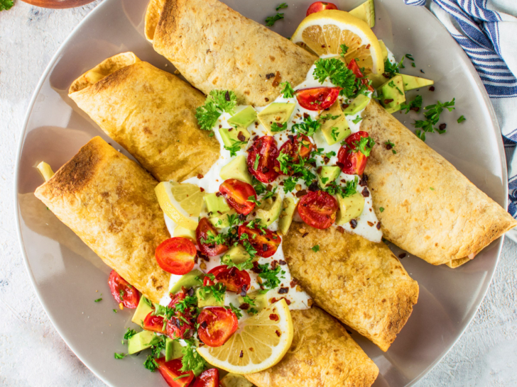 Air fryer taquitos on a grey plate.