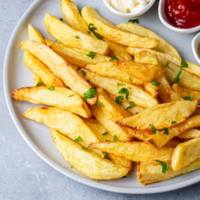 homemade air fryer french fries on a blue plate.