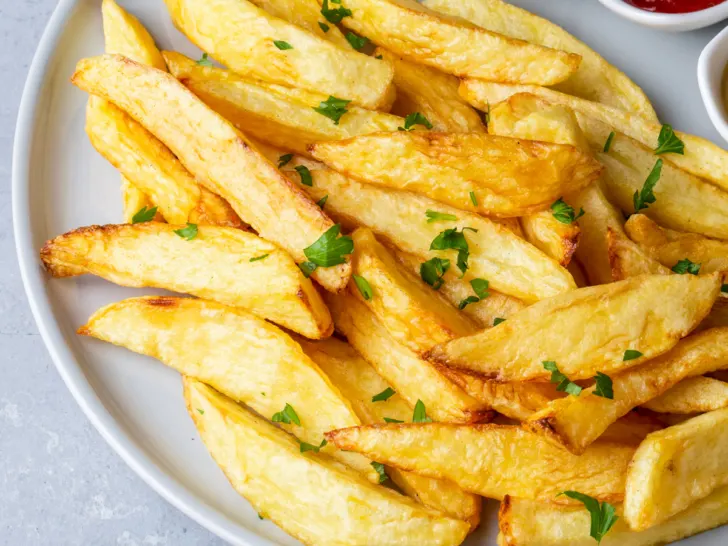 homemade air fryer french fries on a blue plate.