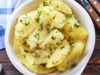 Microwave boiled potatoes in a white bowl.