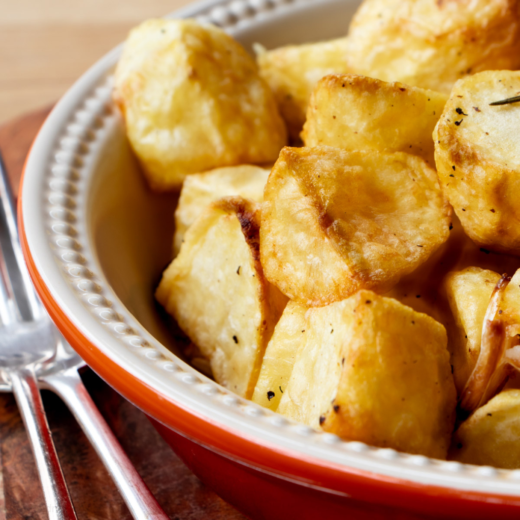 Air fried roast potatoes in a white bowl.