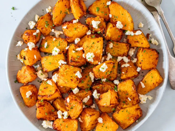 Air fryer pumpkin with feta on a white plate.