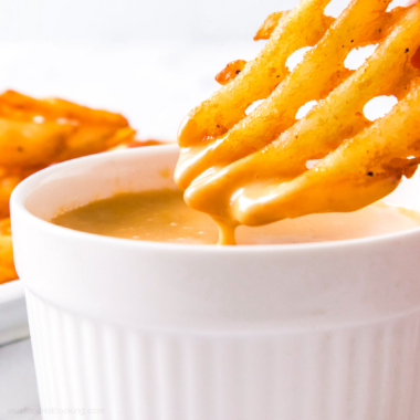 A bowl of homemade Chick-fil-a sauce with waffle fries.