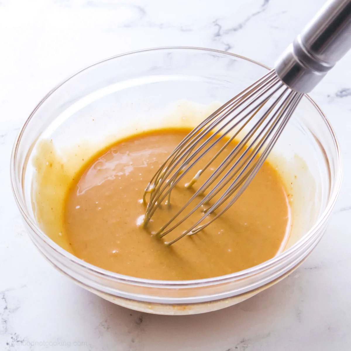 Freshly made Chick-fil-A sauce in a bowl with a whisk. 