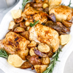 Air fryer bone-in chicken thighs on a white plate.