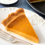 A slice of air fryer pumpkin pie on a white plate.