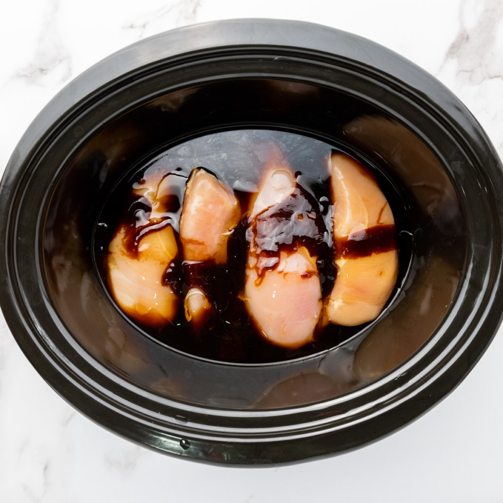 Chicken breast and teriyaki sauce in the slow cooker.