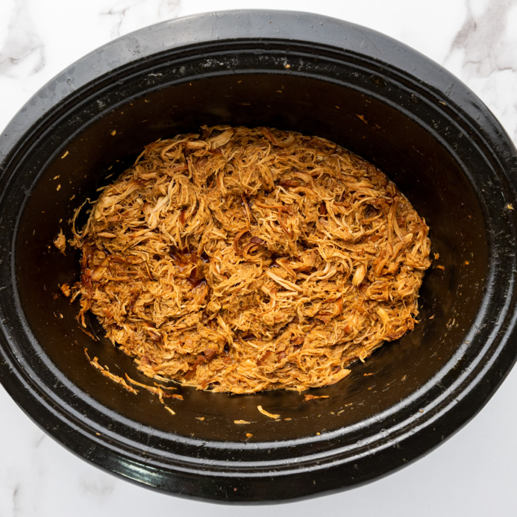 Shredded teriyaki chicken breast in the slow cooker.