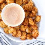 Air fryer popcorn shrimp on a white plate.