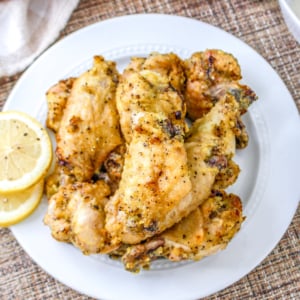 Air fryer chicken wings on a white plate.