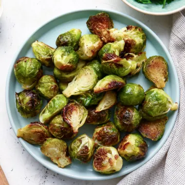 Air fryer Brussels sprouts on a blue plate.