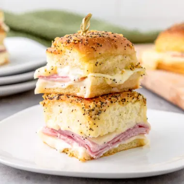 Air fryer ham and cheese sliders on a white plate.