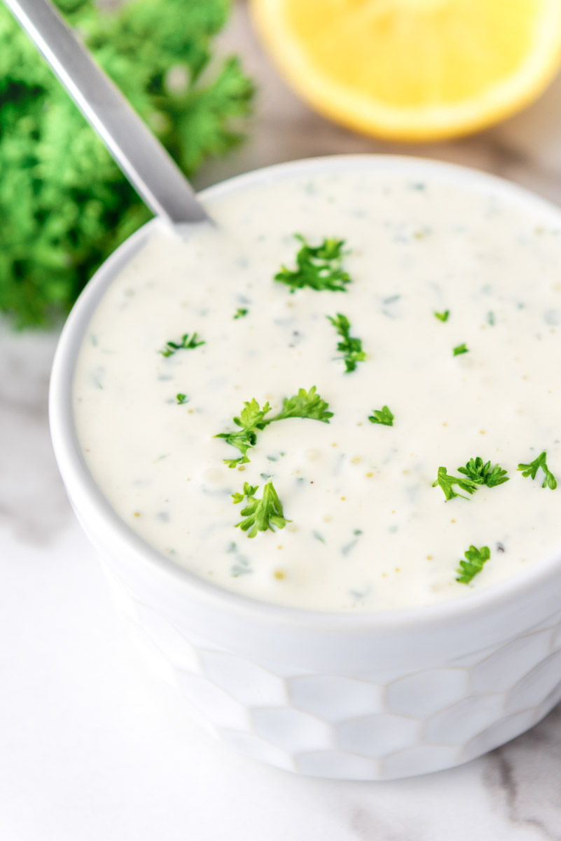 Creamy garlic dip in a white bowl.