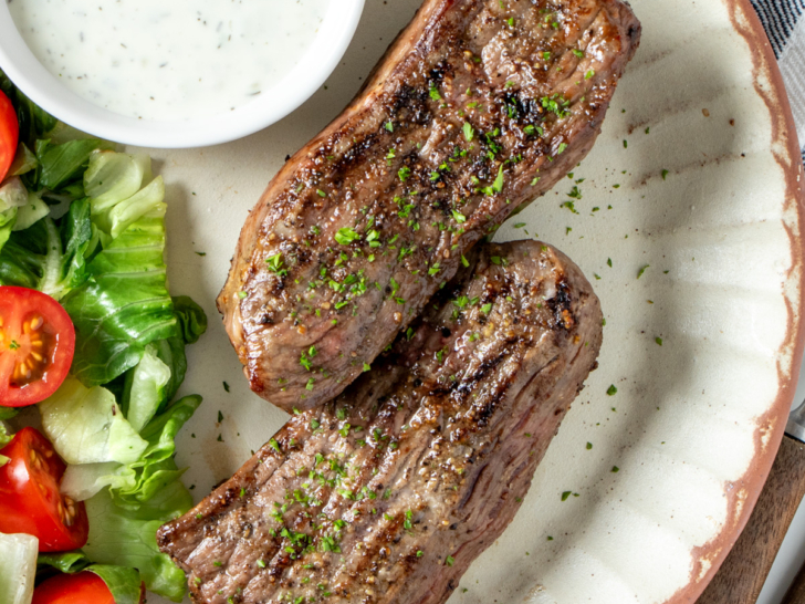 Air fryer lamb steaks on a plate with salad.