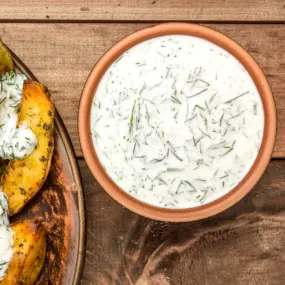 Simple dill mayo in a brown bowl.