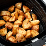 finish-potatoes-in-air-fryer-s Crispy potatoes in air fryer basket.