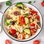 Mediterranean orzo salad in a white bowl.