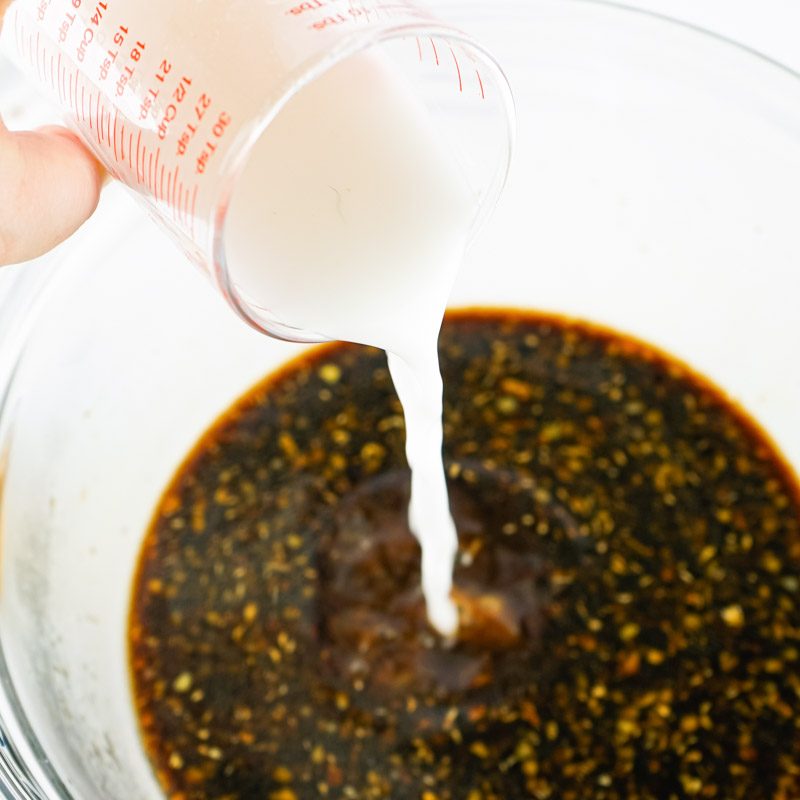 Cornstarch being added to teriyaki sauce. 