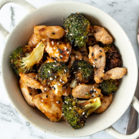 Air fryer chicken and broccoli in a white bowl.