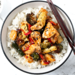 Air Fryer Chicken and Vegetable Stir Fry Served Over Rice.