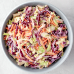 Classic creamy coleslaw in a grey bowl.