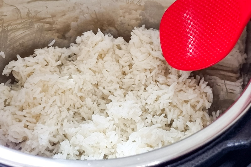 Cooked jasmine rice in the Instant Pot with rice paddle.