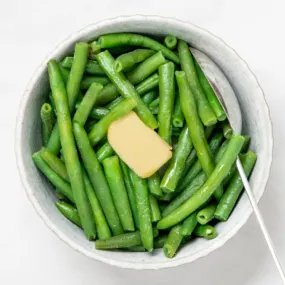 Microwaved frozen green beans topped with melting butter.