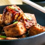 Crispy air fryer tofu in a black bowl.