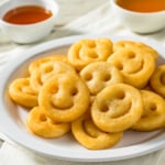 Air fried Mccain smiles on a white plate.