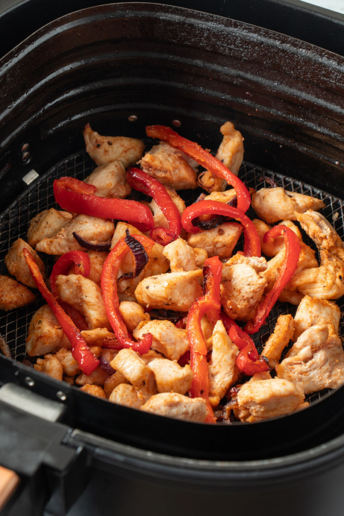 Air fried fajita filling in air fryer basket. 