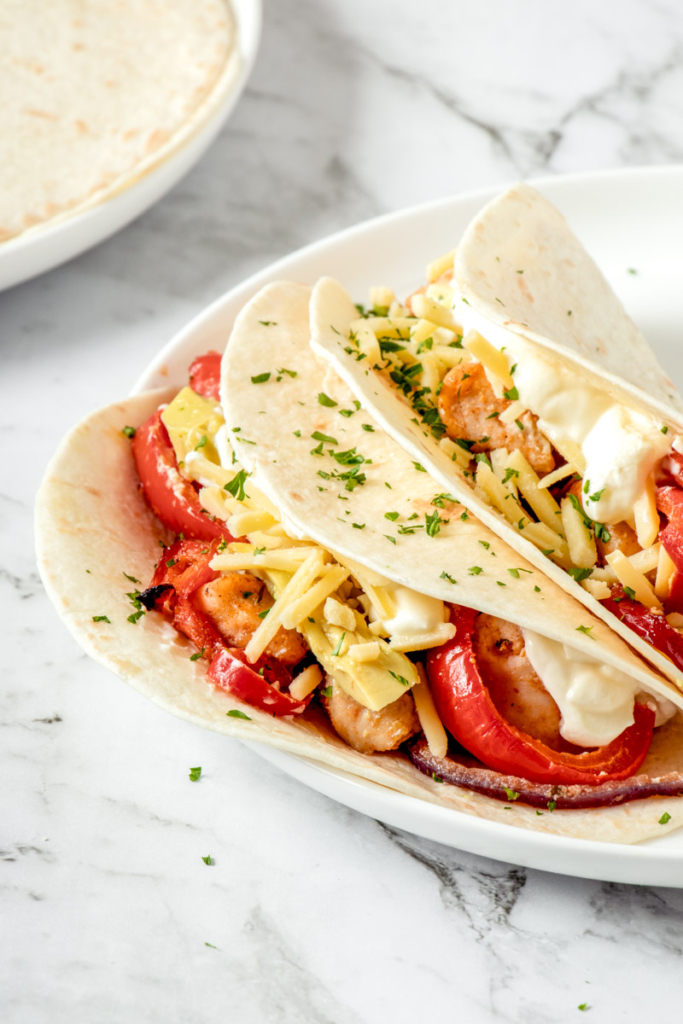 Air fryer chicken fajitas on a white plate.