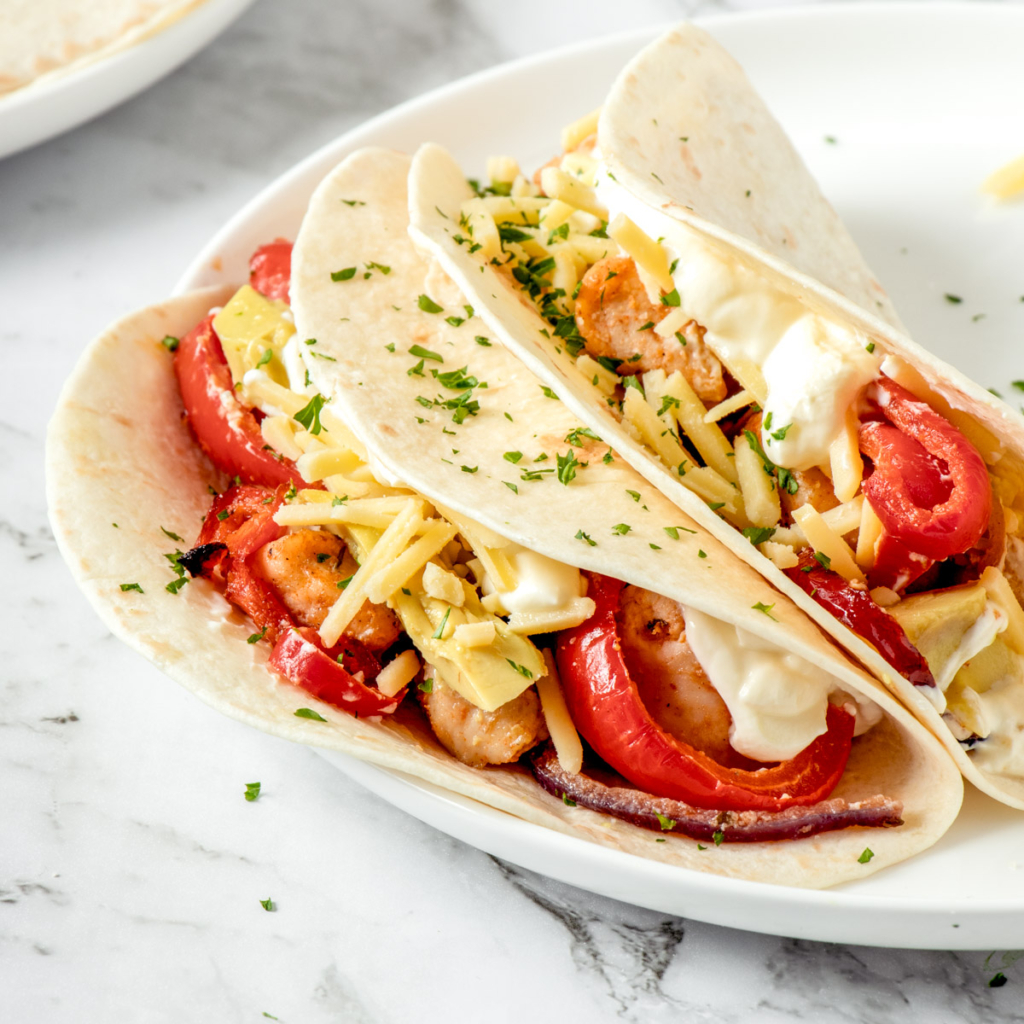 Air fryer fajitas on a white plate.