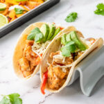 Sheetpan chicken fajitas with fresh cilantro and avocado.