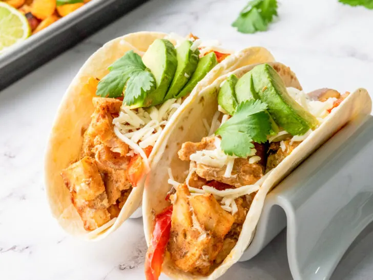 Sheetpan chicken fajitas with fresh cilantro and avocado.