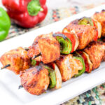 Air fryer chicken kababs on a white plate.
